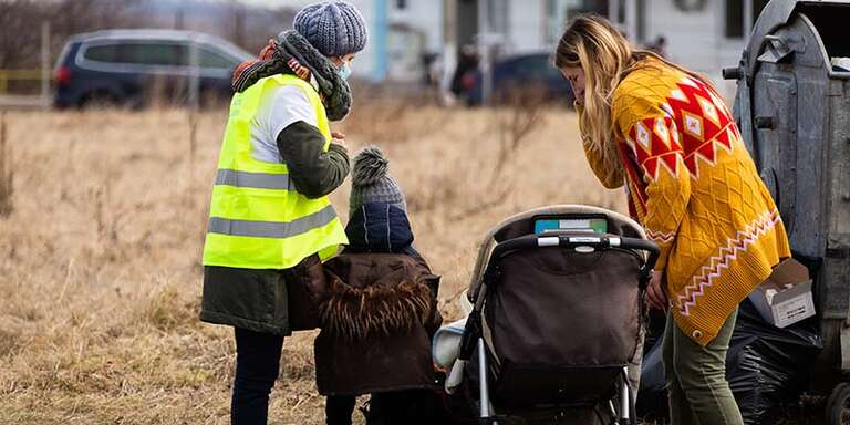 Ukrainian families and children crossing the border into Romania to escape conflict.