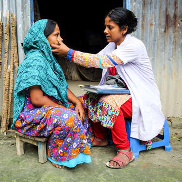 Bangladesh doctor making a house call and providing consultation.