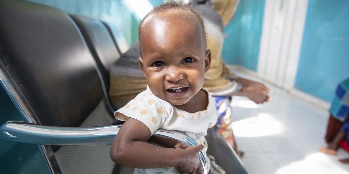 A baby girl who had been suffering from severe acute malnutrition sits in a chair in a hospital in Somalia.