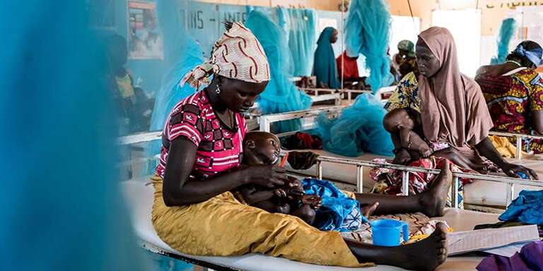 In Niger, a mother feeds her baby in a hospital.