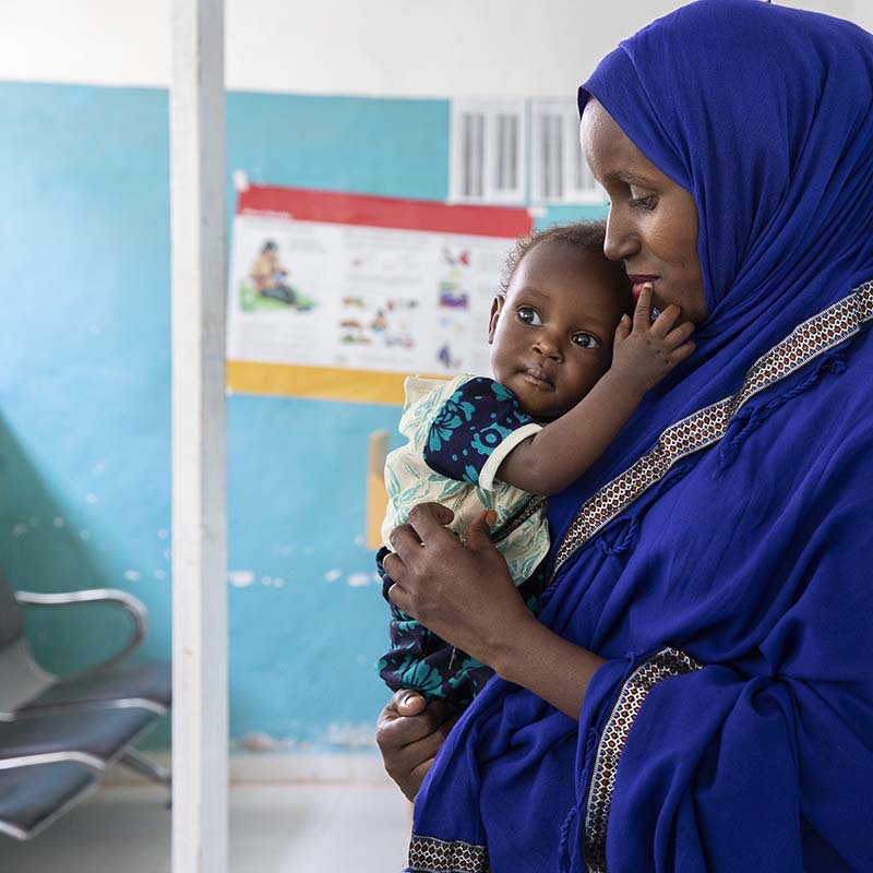 In Somalia, a mother holds her baby boy who is being treated for malnutrition.