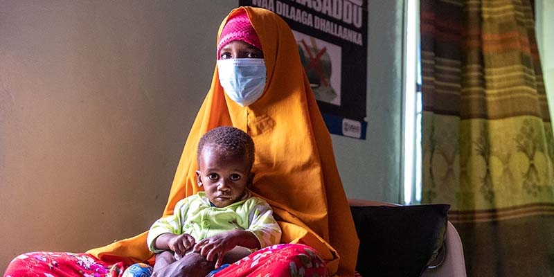 In Somalia, a mother sits with her child who is being treated for malnutrition. 