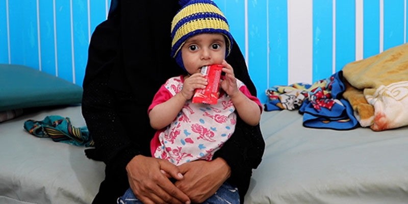 In Yemen, a young child receives treatment for malnutrition at a health center where children facing starvation are seen.