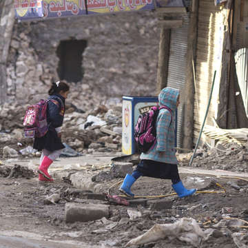 Children walk home from school in Mosul, Iraq in January 2019. The city of Mosul was severely damaged in fighting. Much of the housing was reduced to rubble.  Credit: Sam Tarling / Save the Children