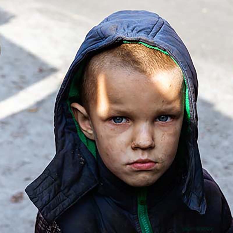Ukraine, a young boy, stands near his house in Kyiv after a blast.
