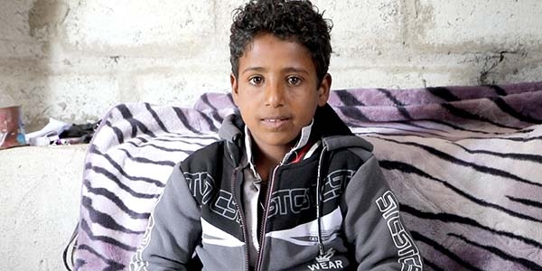 Yemen, a little boy looks to the camera, smiling.