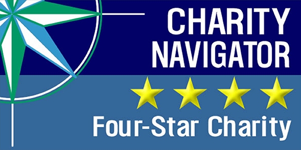 Charity Navigator’s logo for a four-star charity rating includes four gold stars against a blue background. 