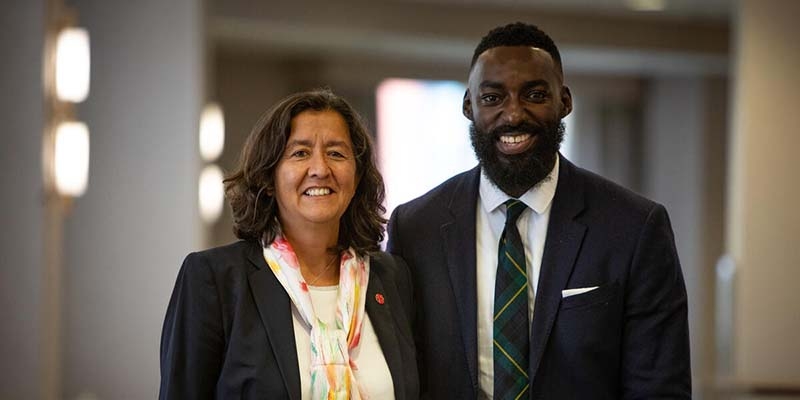 Janti Soeripto, President & Chief Executive Officer of Save the Children US, stands next to Chef Eric Adjepong.