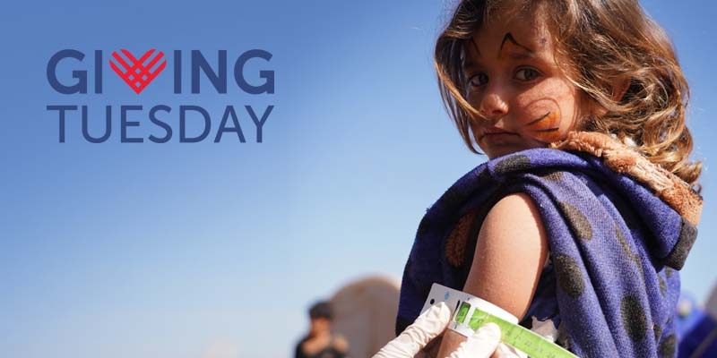 The Giving Tuesday logo is overlaid on an image of a girl being screened for malnutrition.