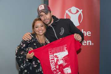 Enrique Iglesias meets Sheila Gutierrez Romero, who teaches children enrolled in Save the Children's Healing and Education for the Arts or HEART program in Mexico City, backstage at his concert in Las Vegas on Sept. 15, 2017.