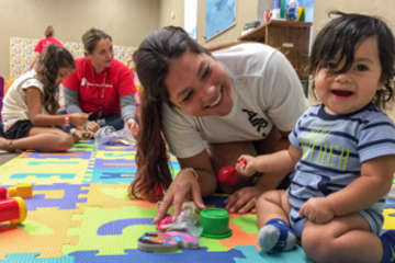 Mario*, 9-months-old, plays with his mother Emily in Save the Children's child-friendly space