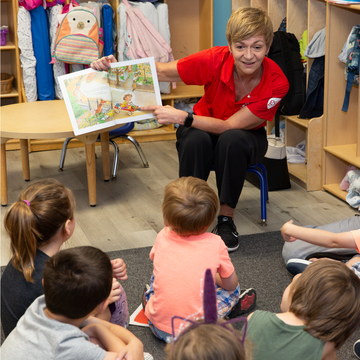 Anne Belcher, SVP Respiratory & US Pharma Operations, GSK, reads to children at Easter Seals UPC in Wilmington, N.C. on May 23, 2019. The child care center was significantly damaged by Hurricane Florence in September 2018 and Save the Children has supported its operations and recovery since the earliest days of the storm. Photo credit: Eric Atkinson / Save the Children 2019.