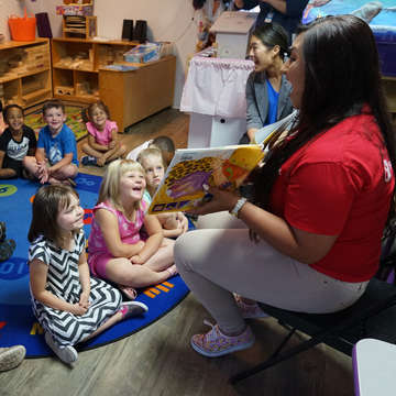 Save the Children staff member Kassi Starrine reads to children at a child care center supported by Save the Children in the aftermath of Hurricane Michael. Save the Children has helped more than 90 child care centers recover and reopen across the Florida Panhandle, so they can once again provide crucial early learning opportunities for the region’s kids. Photo by Elissa Miolene for Save the Children.
