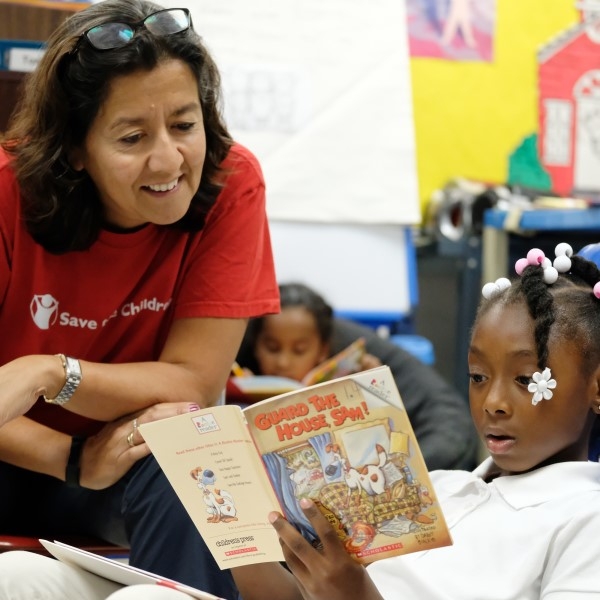 Save the Children's COO, Janti Soeripto, speaks with second grader Kaliyah about her book during guided independent reading on Thursday, September 26, 2019 in Ripley, Tenn.