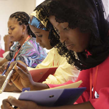 Priceless*, 17, participates in a poetry workshop run by poet Theresa Lola in Nigeria in August 2019. Students analyzed poetry and wrote their own work exploring themes of conflict, education, gender, and discrimination. *Name has been changed. Credit: Save the Children.