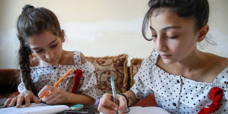 Sisters Amal*, and Lena*, are Syrian refugees in Lebanon whose family situation has become difficult amidst the country's economic crisis. Both were out of school for more than two years but are now registered in Save the Children's educational activities program. Names changed* Credit: Baraa Shkeir/ Save the Children 