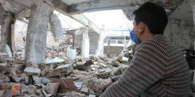 Ten-year old Mustafa* looks out over the damage done to his school in Idlib, North West Syria.
