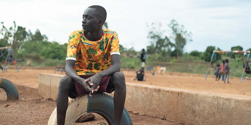 Daniel sits for a portrait in a refugee camp in Uganda.