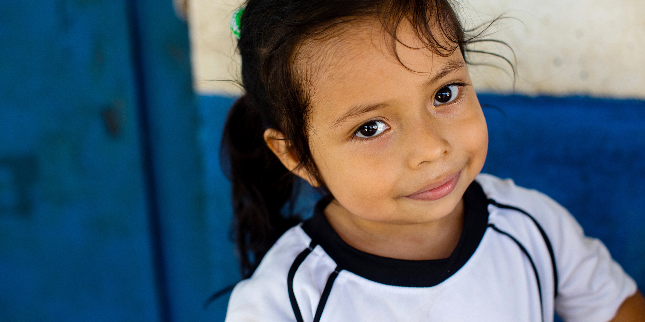 El Salvador, a 4 yr. little girl in the Save the Children sponsorship program smiles at the camera