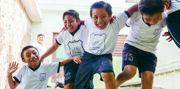 In Mexico, a group of boys play while at recess.