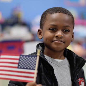 A child holds an American flag.