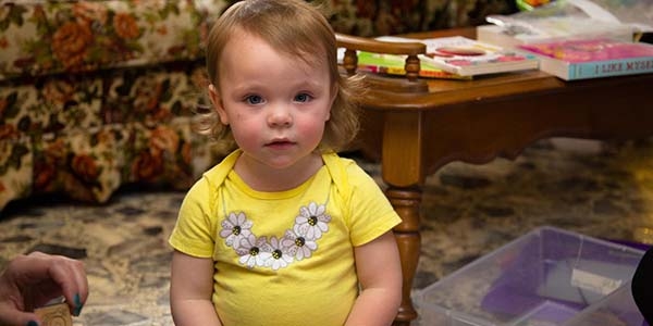 An 18-month old girl stares at the camera during an Early Steps home visit in Kentucky 