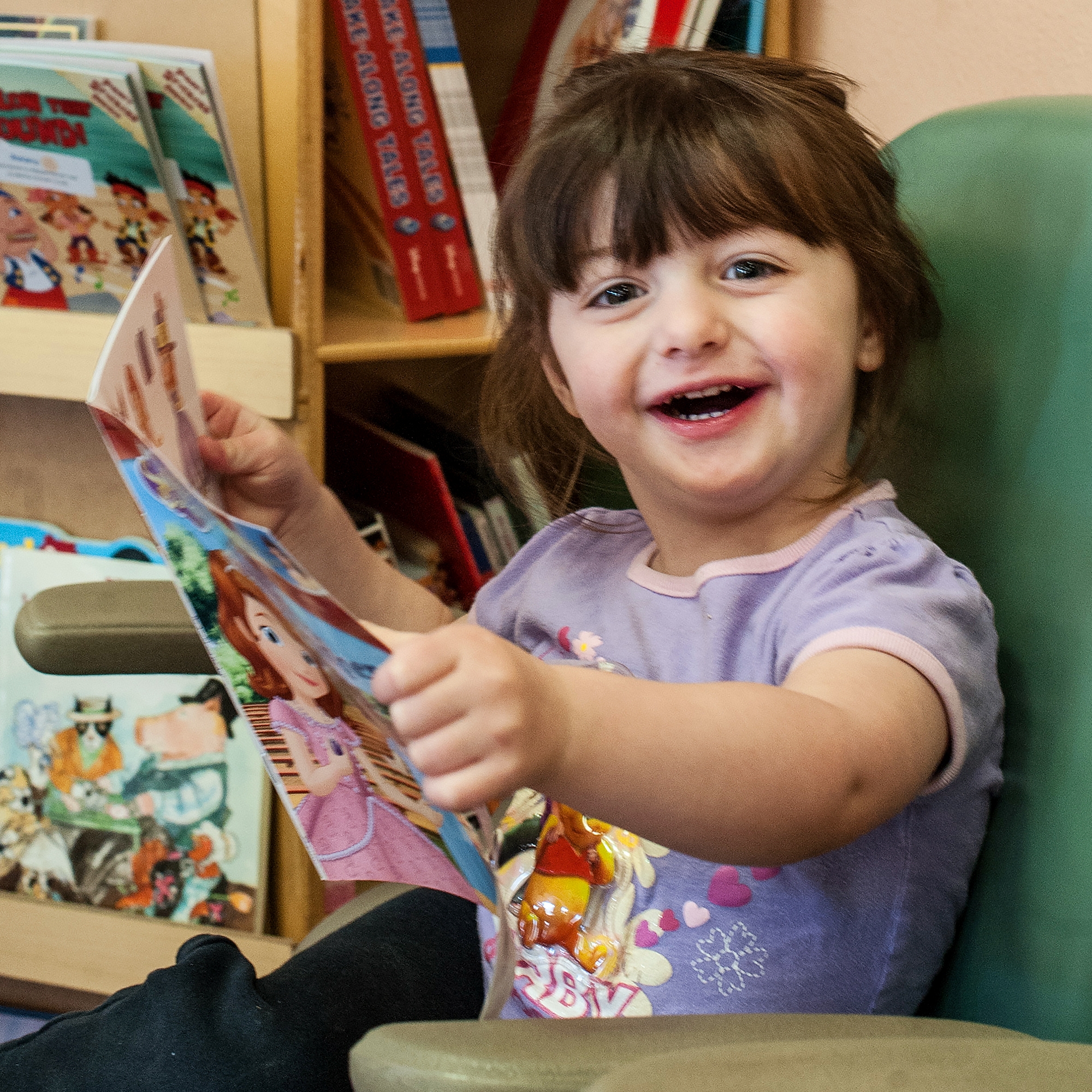 Two-year-old Michelle enjoys the reading corner at the Alamosa Family Medical Center. The reading corner is a new community initiative with local business, housing communities and doctors offices to foster everyday reading with children. Photo credit: Susan Warner / Save the Children 2016.