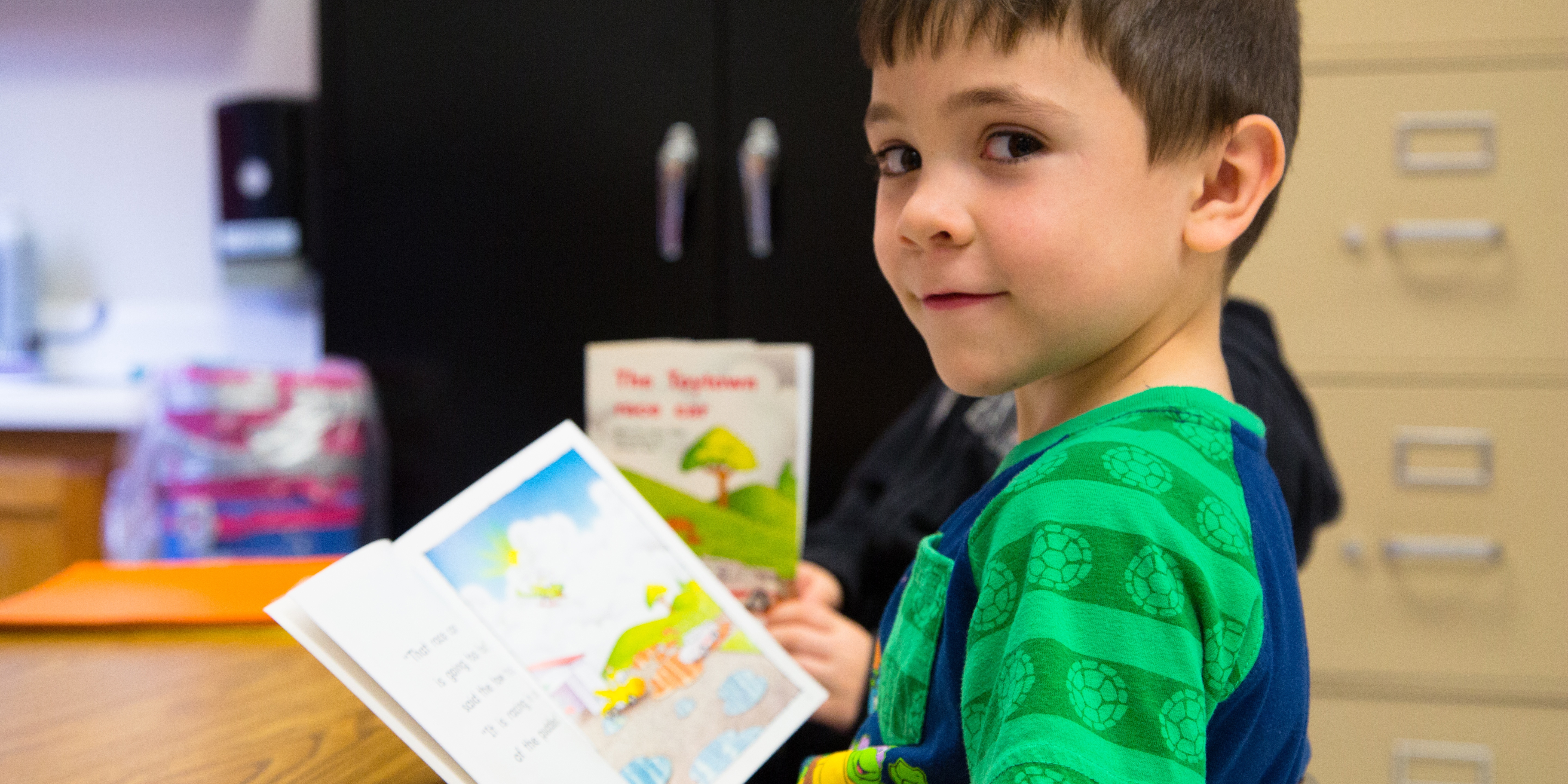 Brantley, 6, pauses while reading a book in his Kentucky classroom. Brantley is part of Save the Children's emergent reader literacy program which provides training, tools and support schools need to accelerate reading growth for struggling readers. Photo credit: Ellery Lamm / Save the Children 2018.