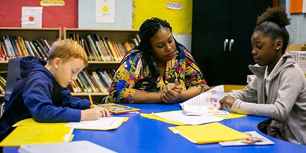 A Save the Children staff member helps students school work in Mississippi.  on Wednesday, November 6, 2019 at their school in Mississippi