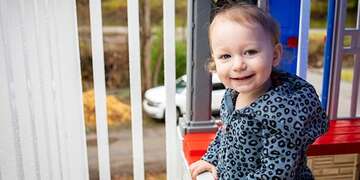 An 18-month-old girl plays outside on the front porch of her home in West Virginia.
