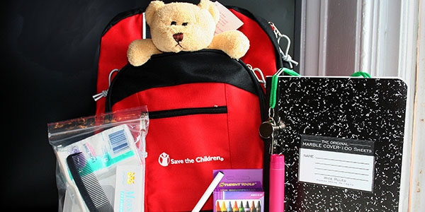 Emergency go-bag filled with teddy bear. school supplies and hygiene items.