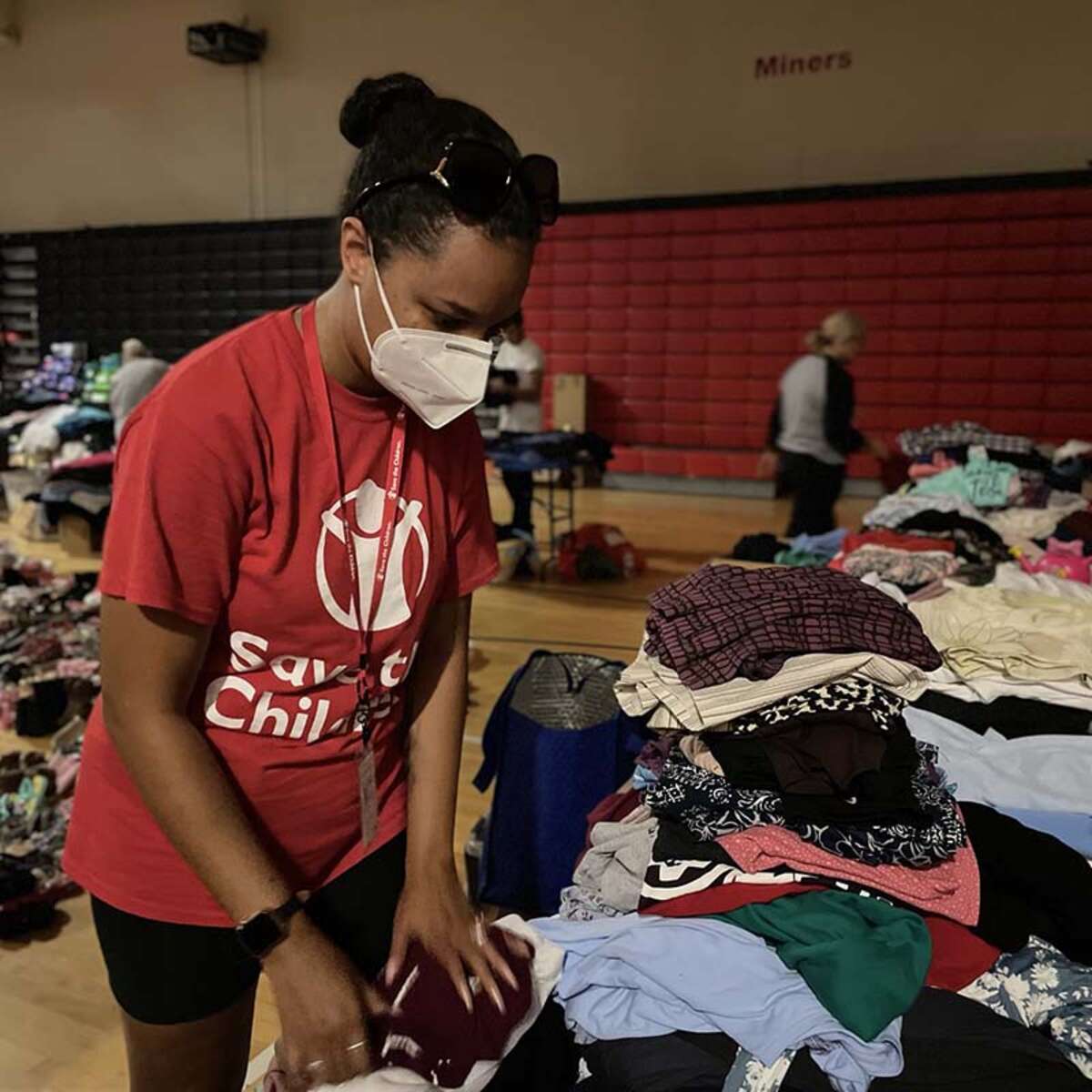  A Save the Children staff member organizes clothes for distribution to families affected by the historic flooding in Eastern Kentucky.