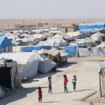 A group of children stand together in a road surrounded by tents in a camp in North East Syria, the area where Turkey has launched a military operation. As a result of the hostilities, already vulnerable families are being forced to flee for safety. Save the Children is working in the three camps to provide much-needed humanitarian aid and support, including tents and food. Photo credit: Save the Children, Oct 2019. 